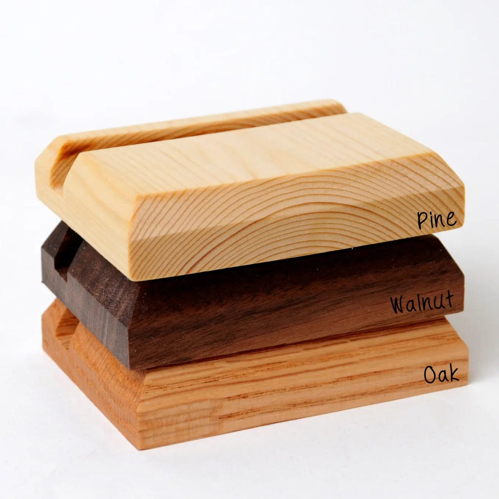 Stacked wood business card holders showing pine, walnut, and oak finishes