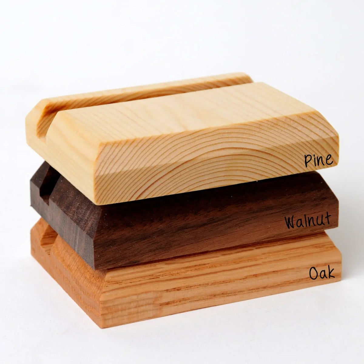 Stacked wood business card holders showing pine, walnut, and oak finishes