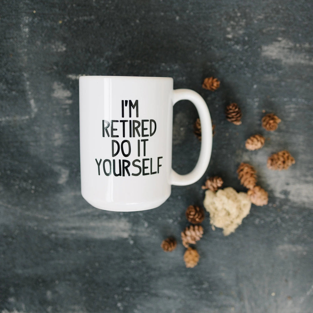 White ceramic coffee mug with "I'm retired do it yourself" print and wide handle
