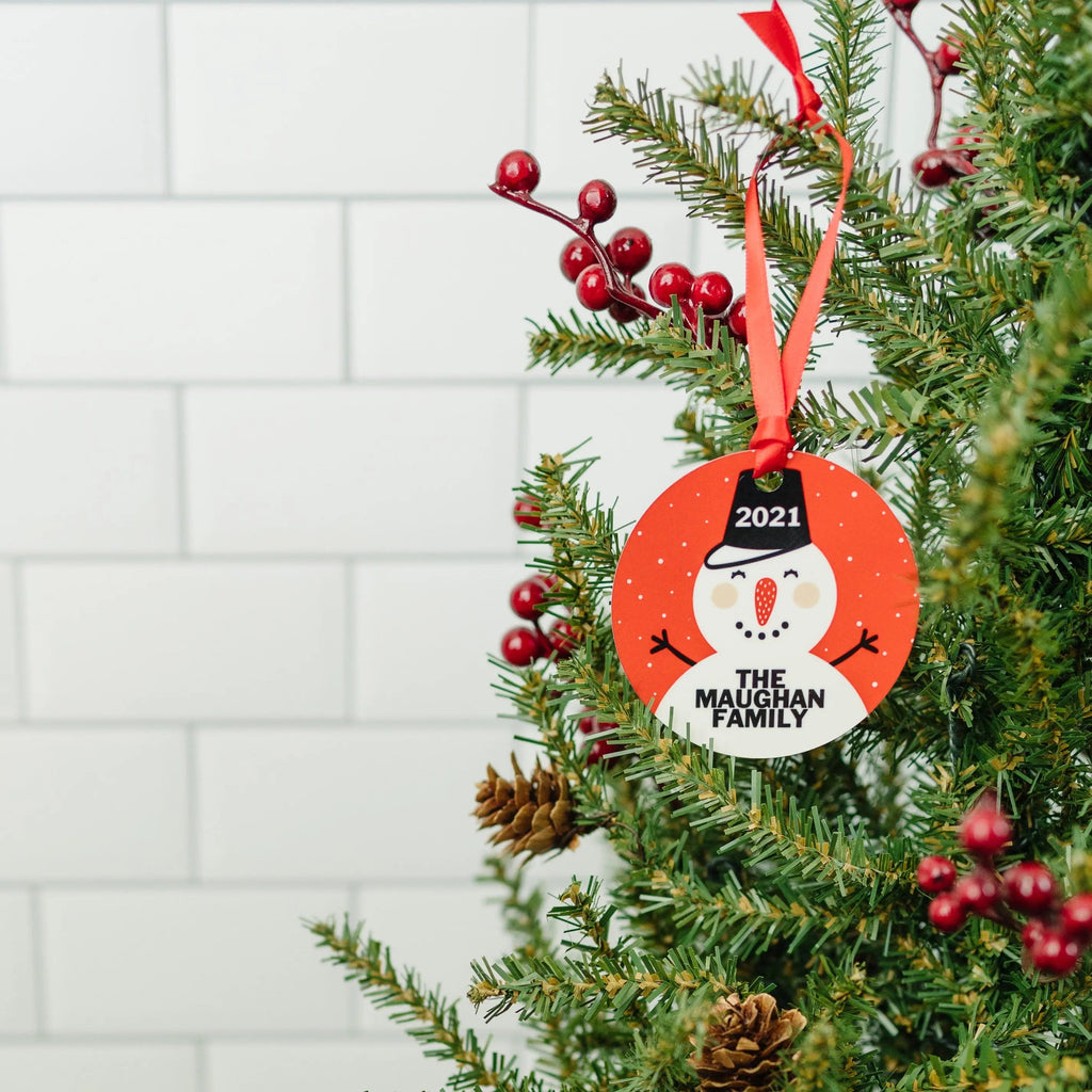 Round snowman Christmas ornament with 2021 and “The Maughan Family” on a red circle