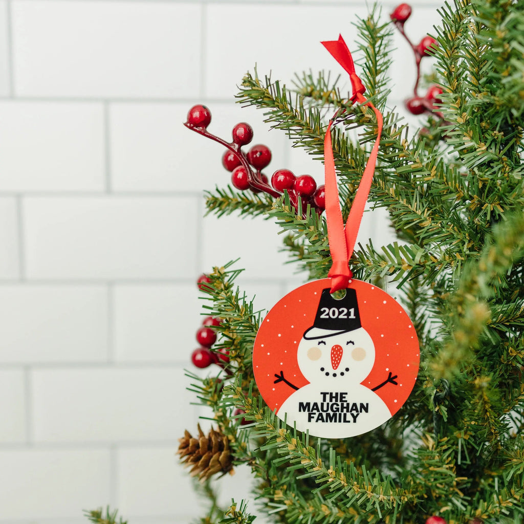 Round snowman Christmas ornament with 2021 and “The Maughan Family” on a red circle
