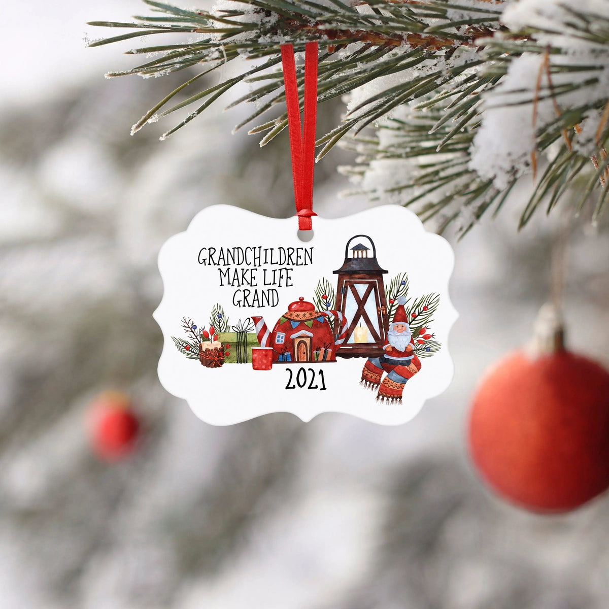 White scalloped Christmas ornament with red hanging ribbon and illustrated 2021 design