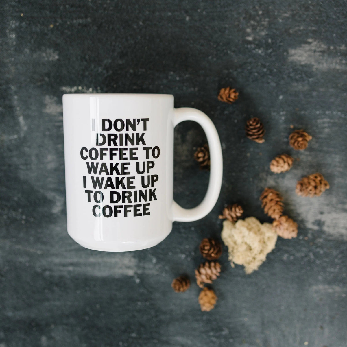White ceramic coffee mug with "I don't drink coffee..." quote in bold black text