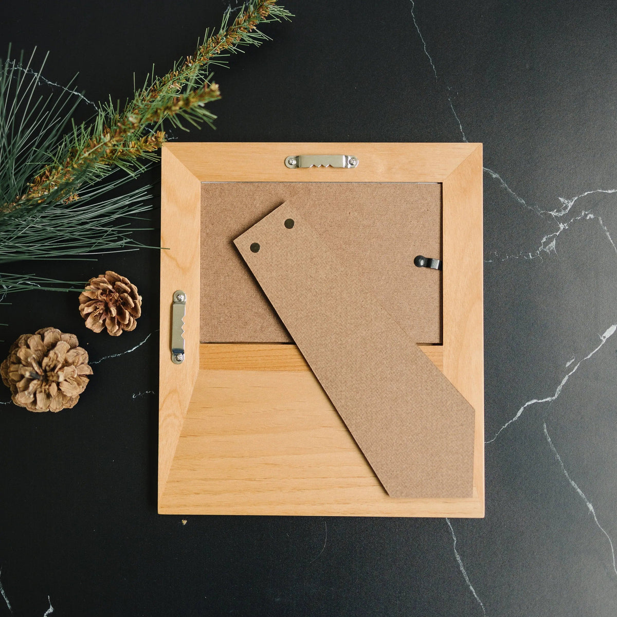 Personalized wood photo frame back with hanging hardware and diagonal backing panel