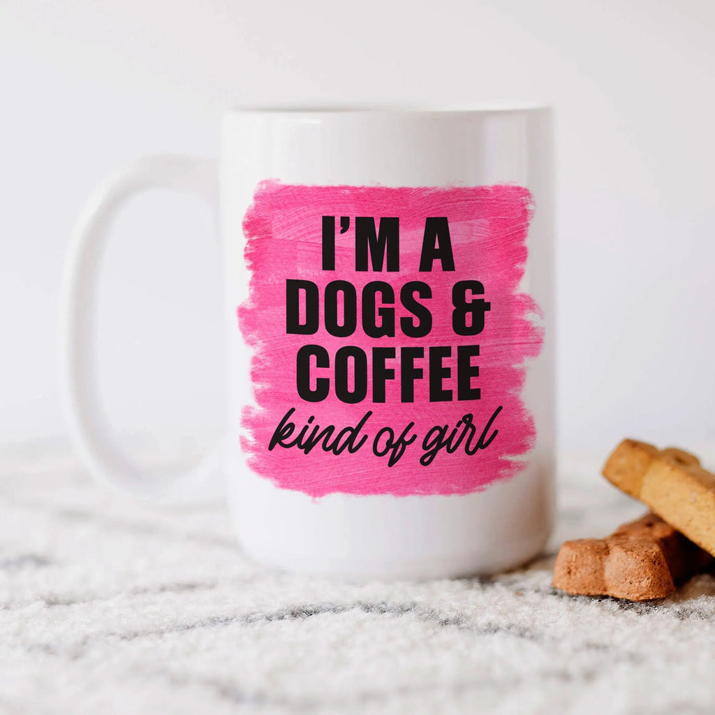 White coffee mug with pink center print: “I'm a DOGS & COFFEE kind of girl”