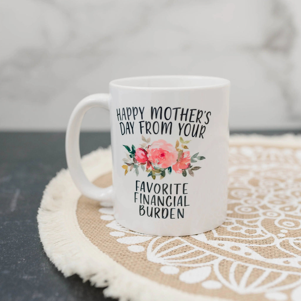 White ceramic coffee mug with floral “Happy Mother’s Day” and “Favorite Financial Burden”