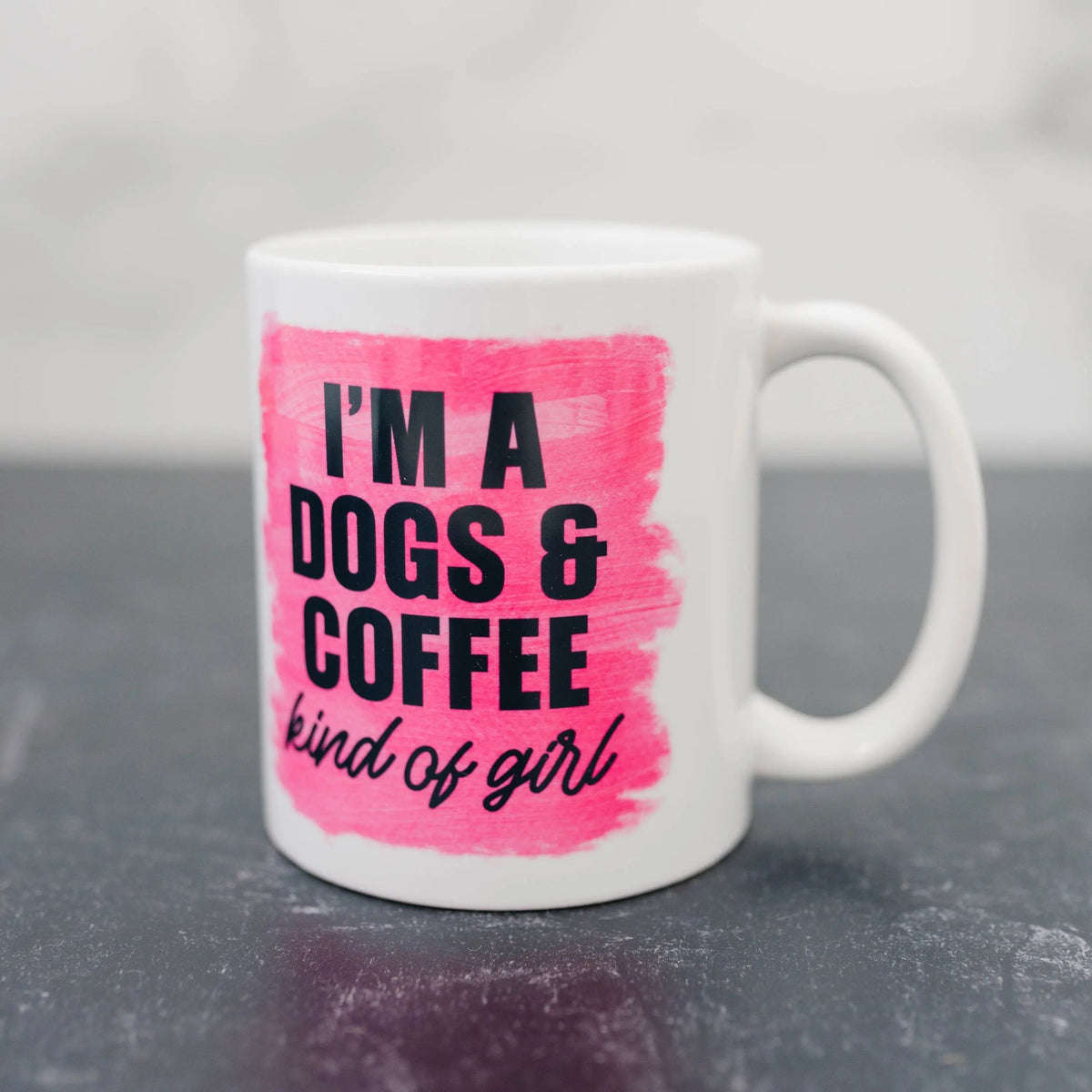 White coffee mug with pink center print: “I'm a DOGS & COFFEE kind of girl”