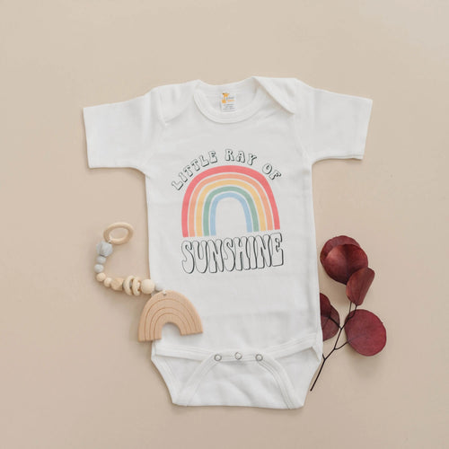 White baby bodysuit with rainbow “Sunshine” graphic, short sleeves, snap bottom