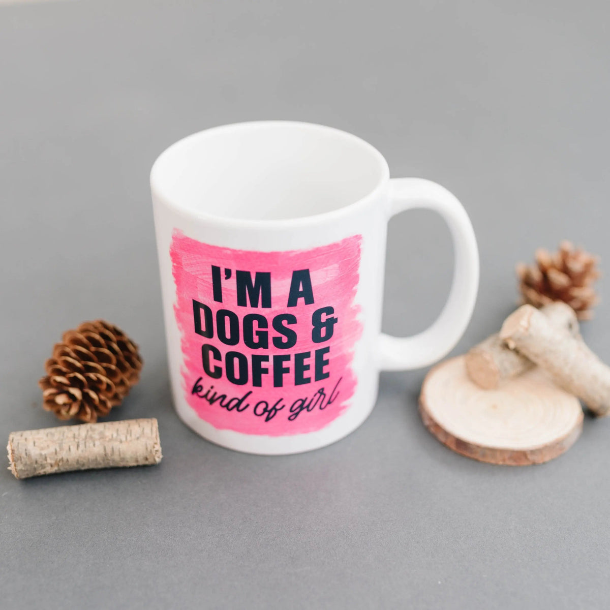 White coffee mug with pink print: “I'm a DOGS & COFFEE kind of girl”