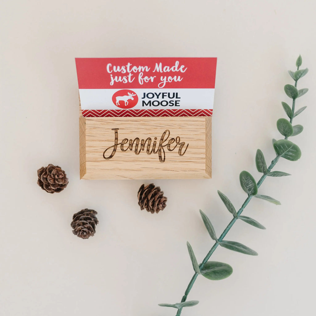 Wood business card holder with engraved name “Jennifer” and gift tag on top