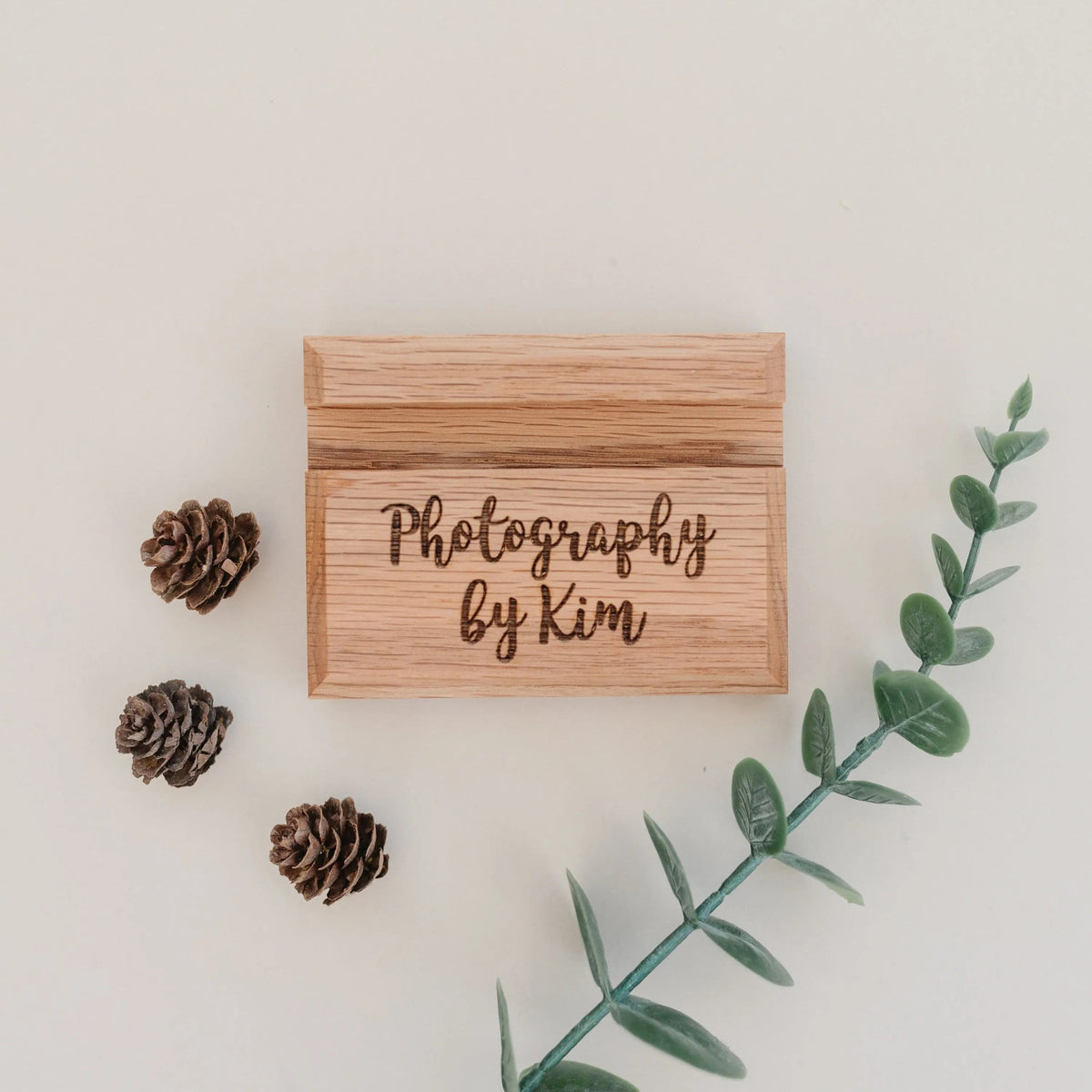 Wood business card holder with engraved text “Photography by Kim”