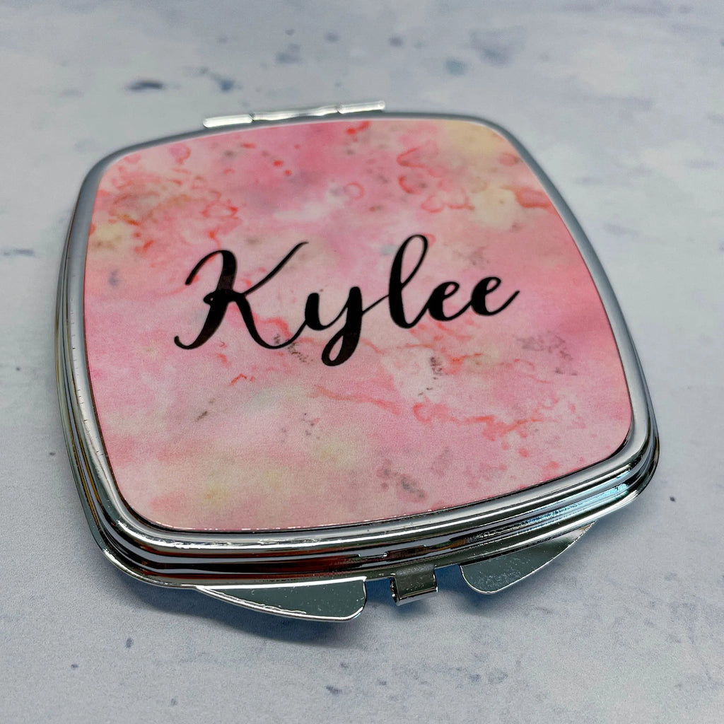 Personalized compact mirror close-up, pink marble lid with 'Kylee' name