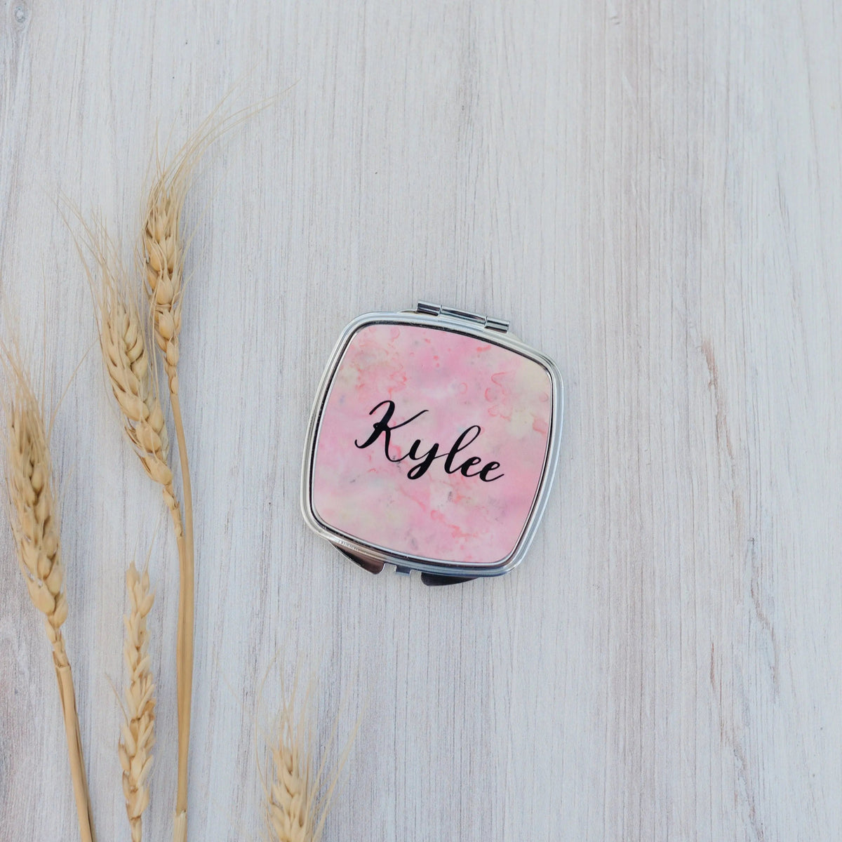 Personalized compact mirror with pink marble front and 'Kylee' name