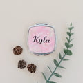 Personalized compact mirror with pink marble cover and 'Kylee' script on front
