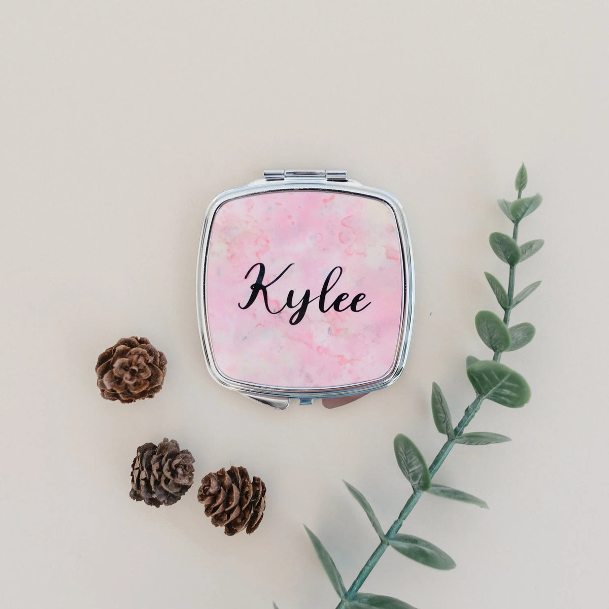 Personalized compact mirror with pink marble cover and 'Kylee' script on front