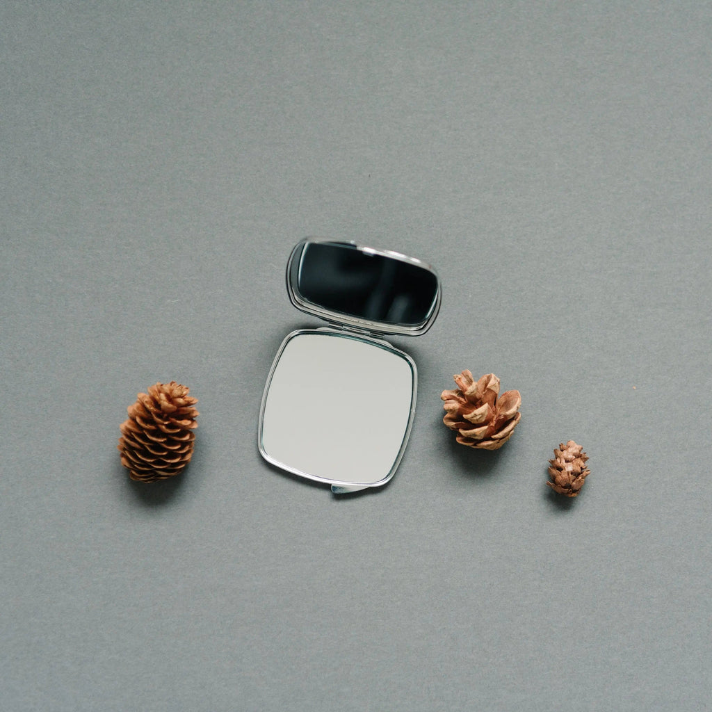 Square pocket compact mirror opened with reflective glass surface
