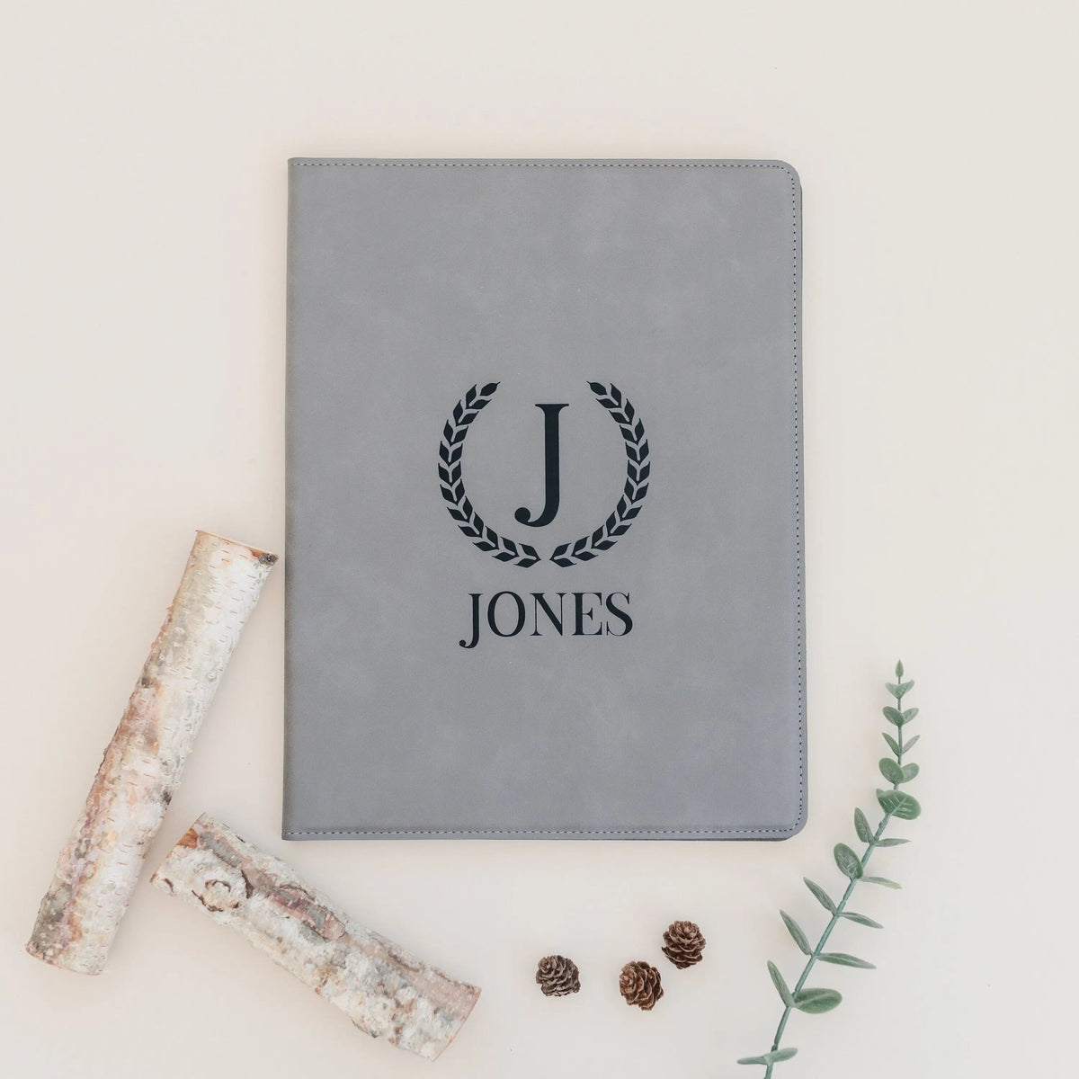 Gray faux leather legal pad portfolio with engraved J and JONES monogram wreath