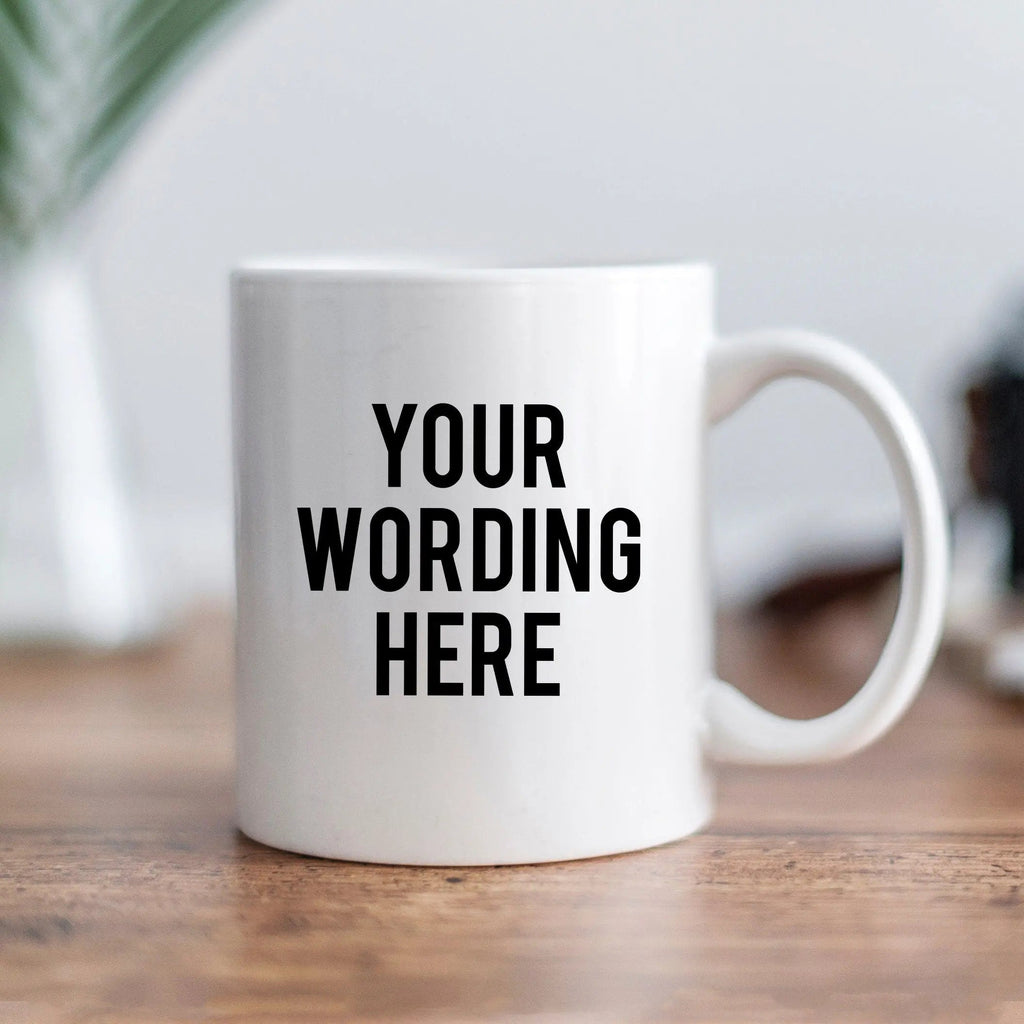 White ceramic mug with black text 'YOUR WORDING HERE' on front
