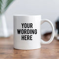 White ceramic mug with black text 'YOUR WORDING HERE' on front