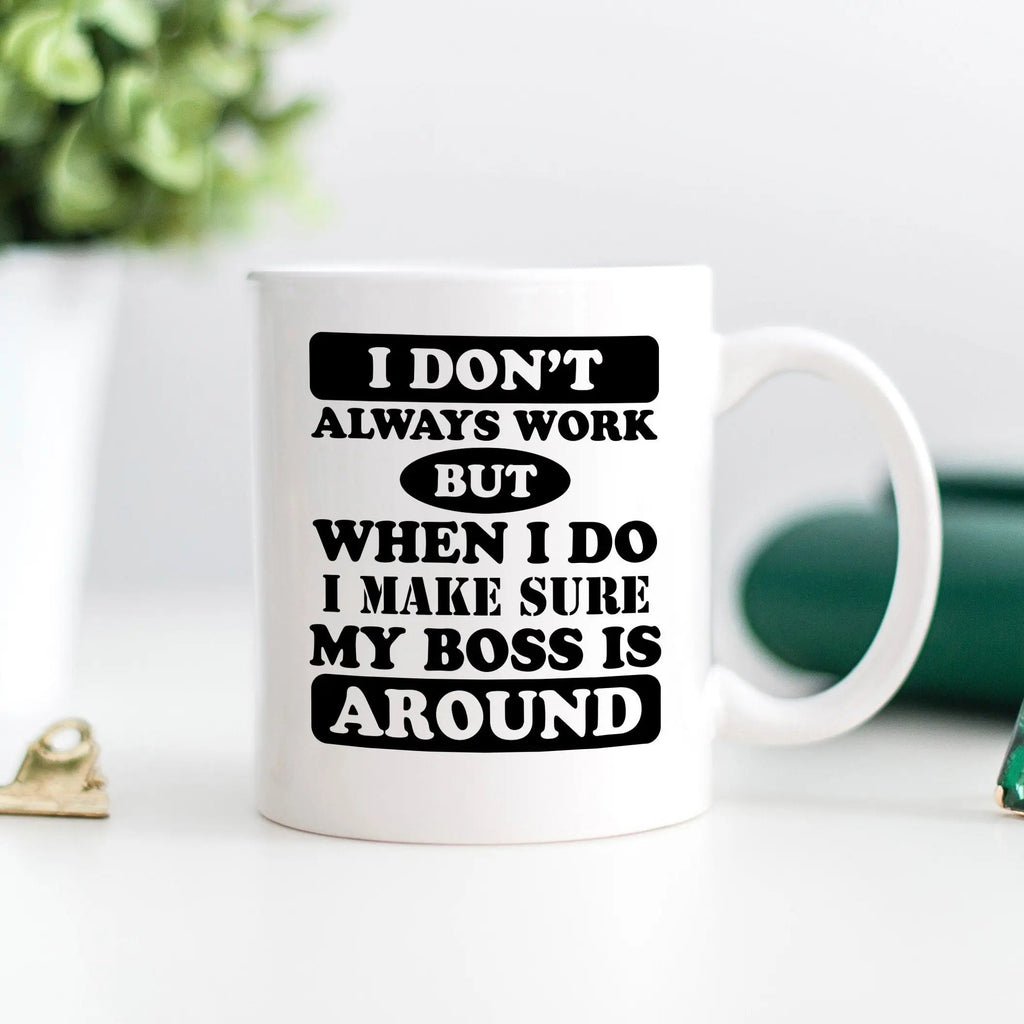 White coffee mug with black text: 'I make sure my boss is around'