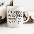 White ceramic coffee mug with “I’m sorry we argued” printed on the front