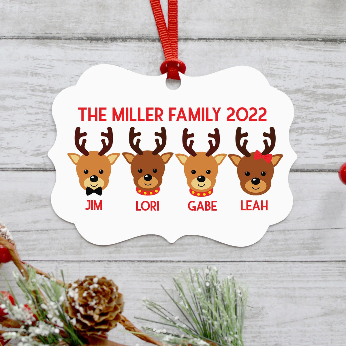 White reindeer family ornament with four reindeer portraits and red ribbon