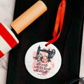 Round Bible verse ornament with sewing machine illustration and red hanging ribbon