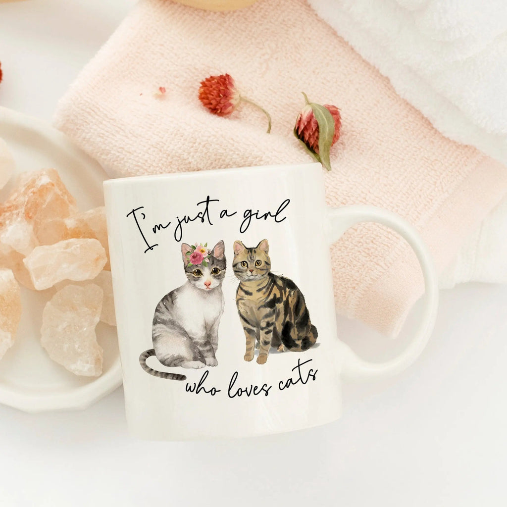 White cat coffee mug with two cat illustrations and script text, large curved handle