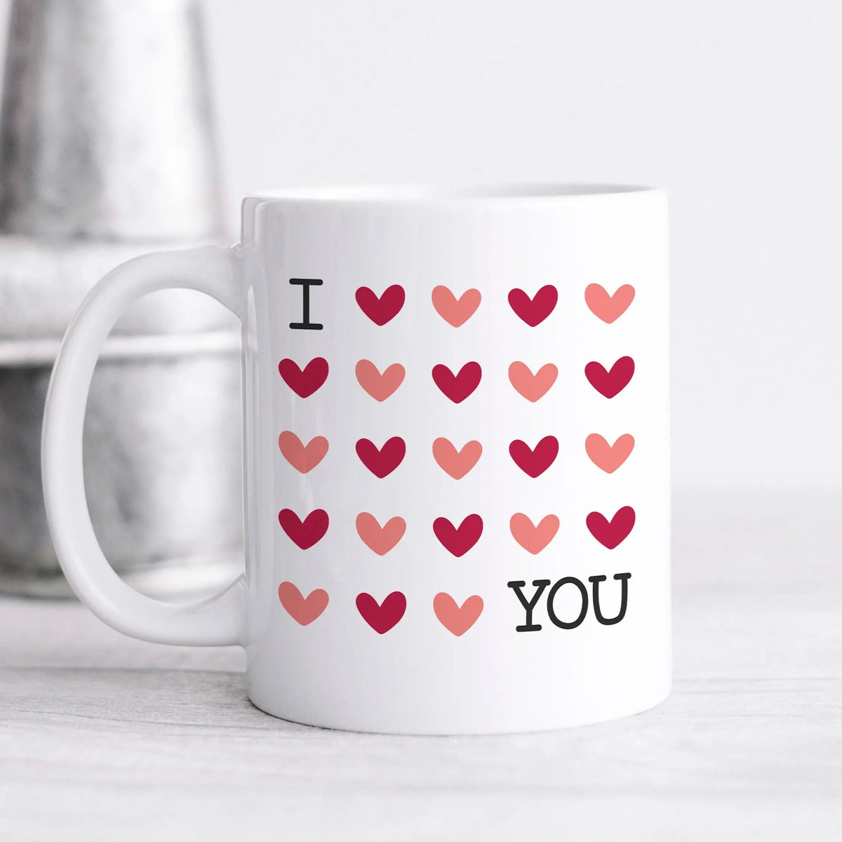 White coffee mug with 'I' and 'YOU' and red heart pattern on front