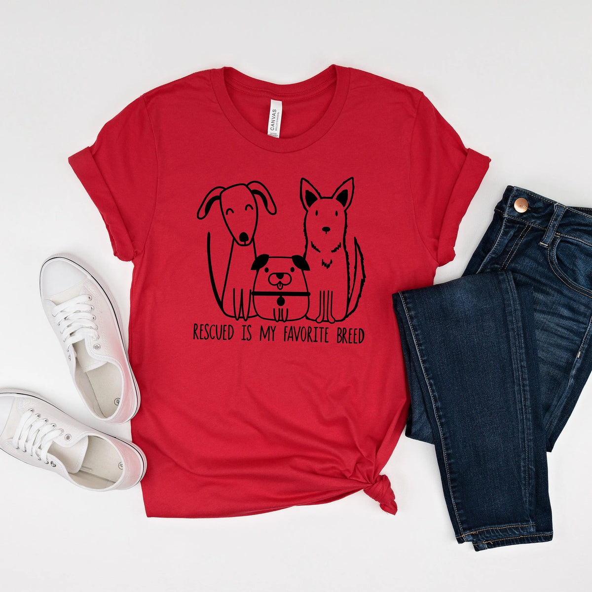 Red unisex T-shirt with dog rescue graphic and text: “Rescued is my favorite breed”.