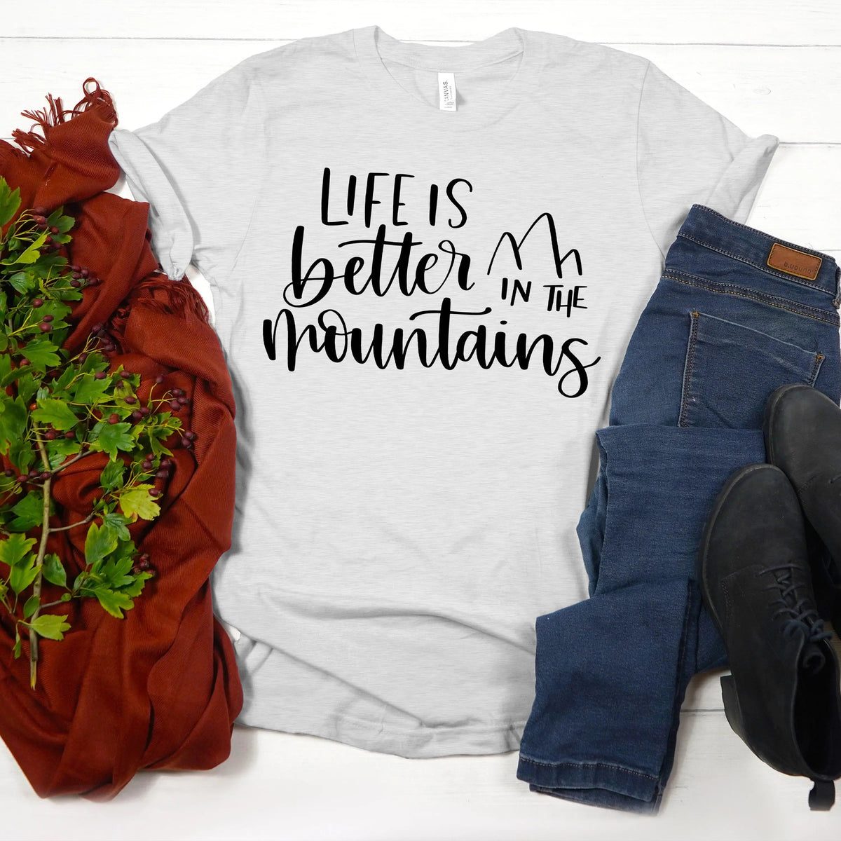 Women’s white T-shirt with “Life is better in the mountains” mountain lettering graphic