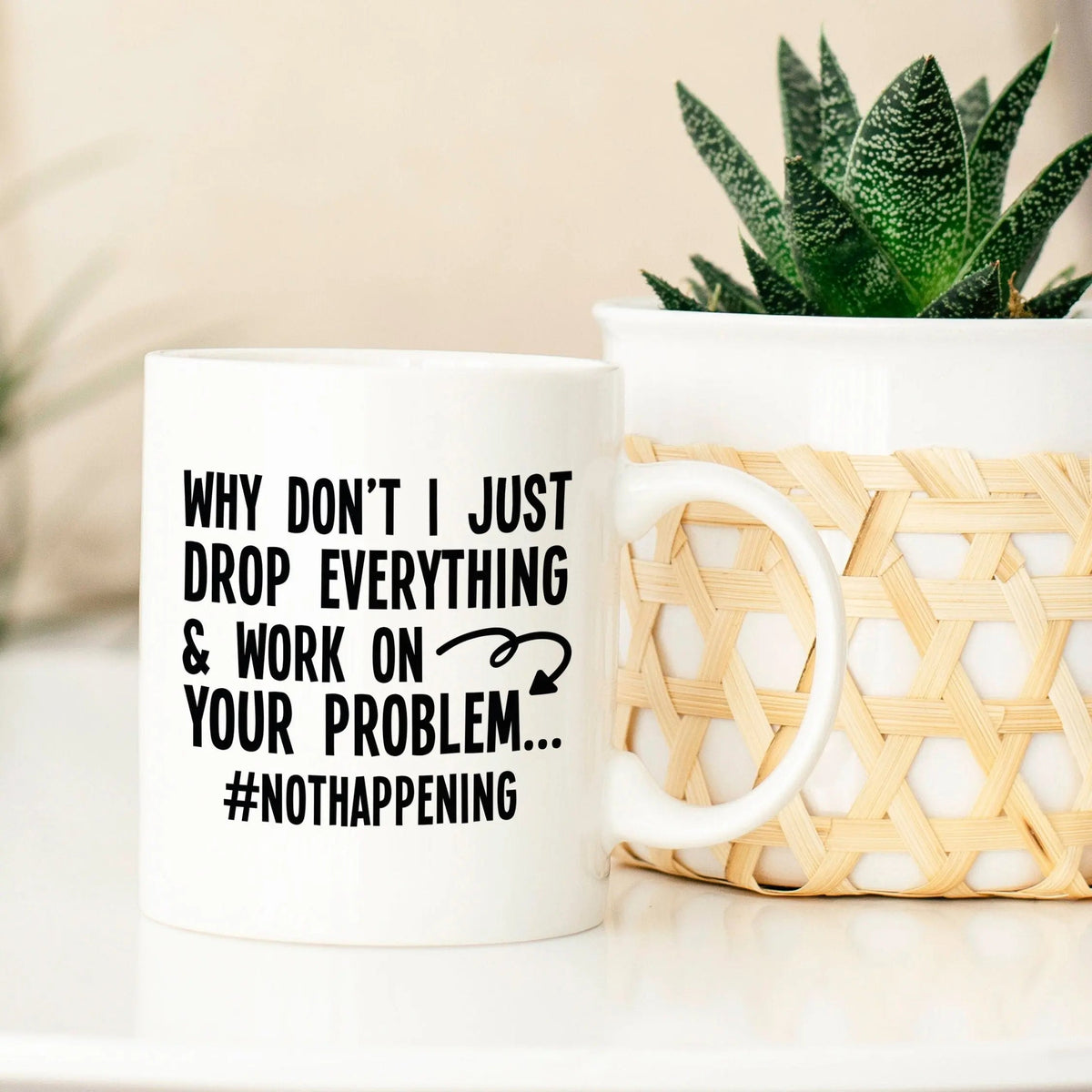 White coffee mug with “#NOTHAPPENING” and sarcastic work quote on the front.