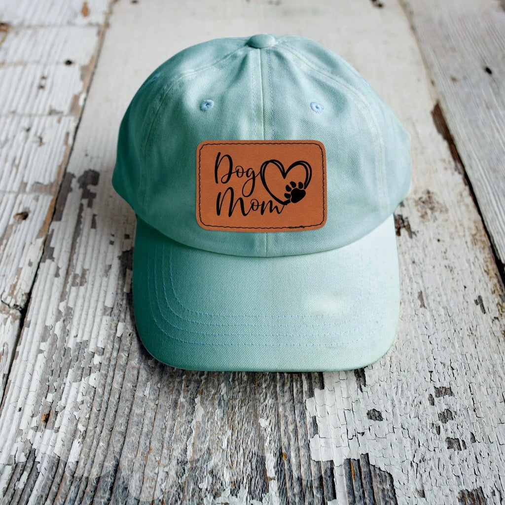 Aqua baseball cap with leather-look patch reading 'Dog Mom' with paw print