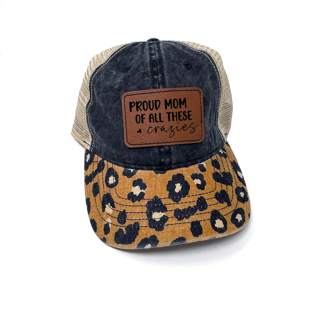 Leopard print trucker baseball cap with brown leather patch and dark denim front