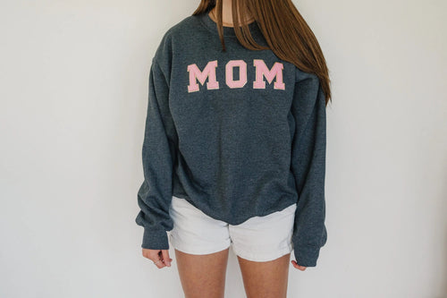 Dark gray crewneck sweatshirt with pink MOM chenille-style patch at chest