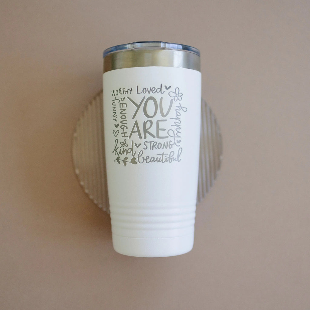 White tumbler with motivational quote and small butterfly icon; stainless steel lid.