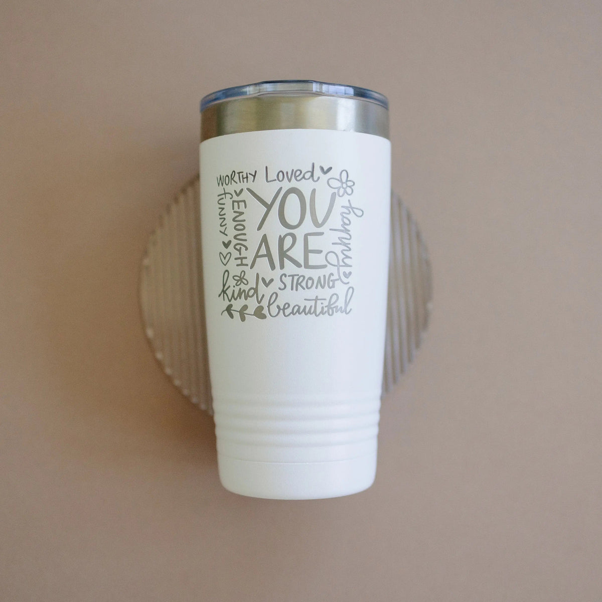 White tumbler with motivational quote and small butterfly icon; stainless steel lid.
