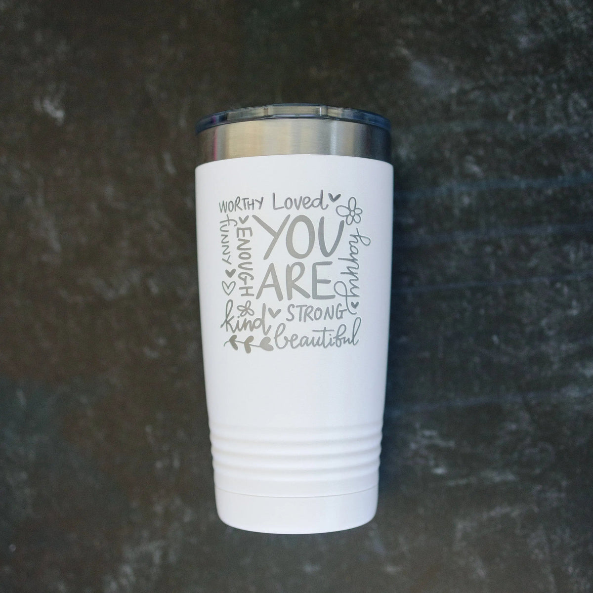 White tumbler with motivational quote and stainless lid, centered close-up front.