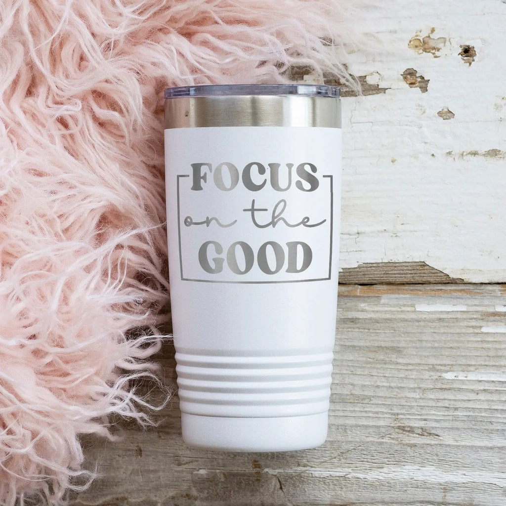 White positive quotes tumbler with “FOCUS on the GOOD” graphic and stainless lid