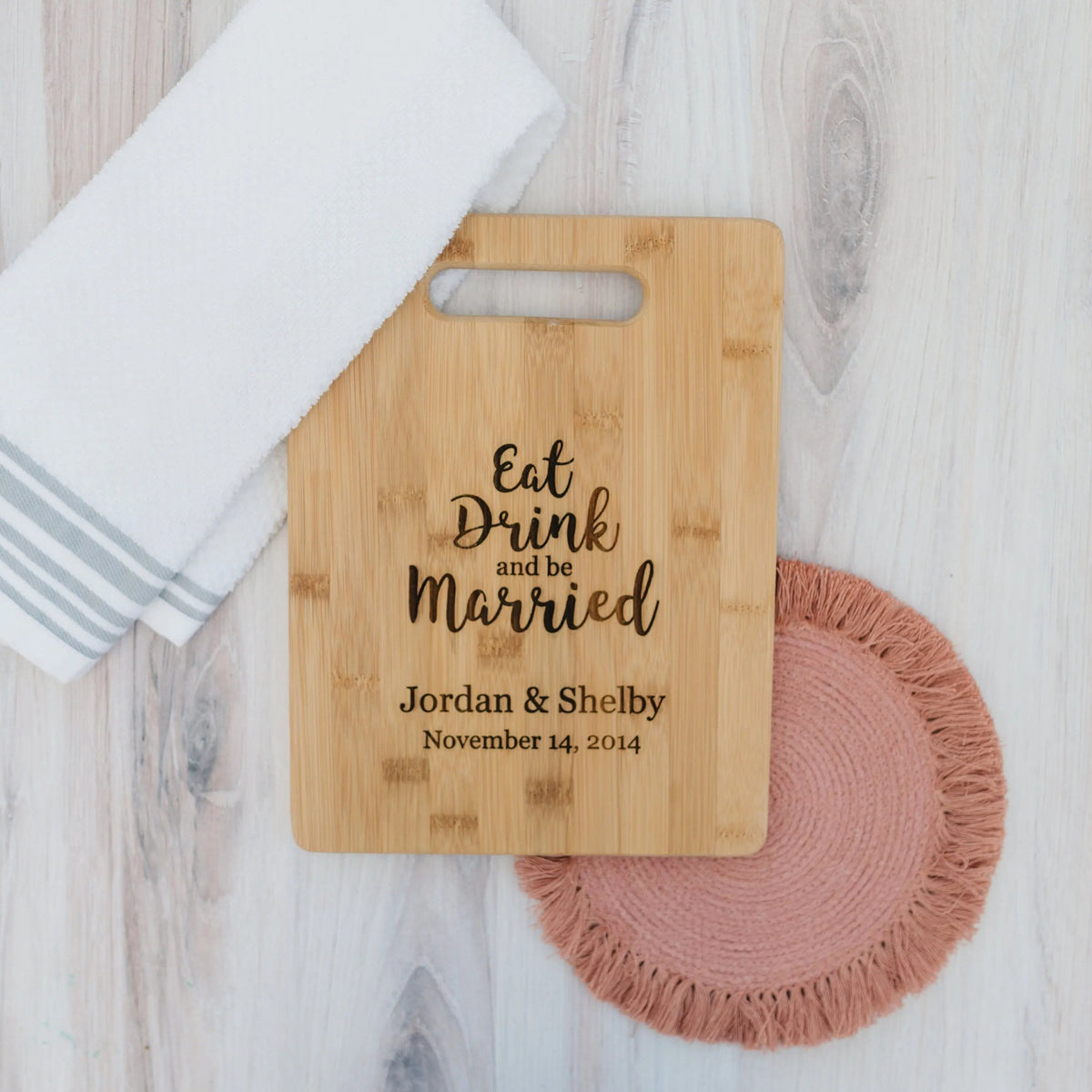 Bamboo cutting board with handle, engraved "Eat Drink and be Married" and wedding date.