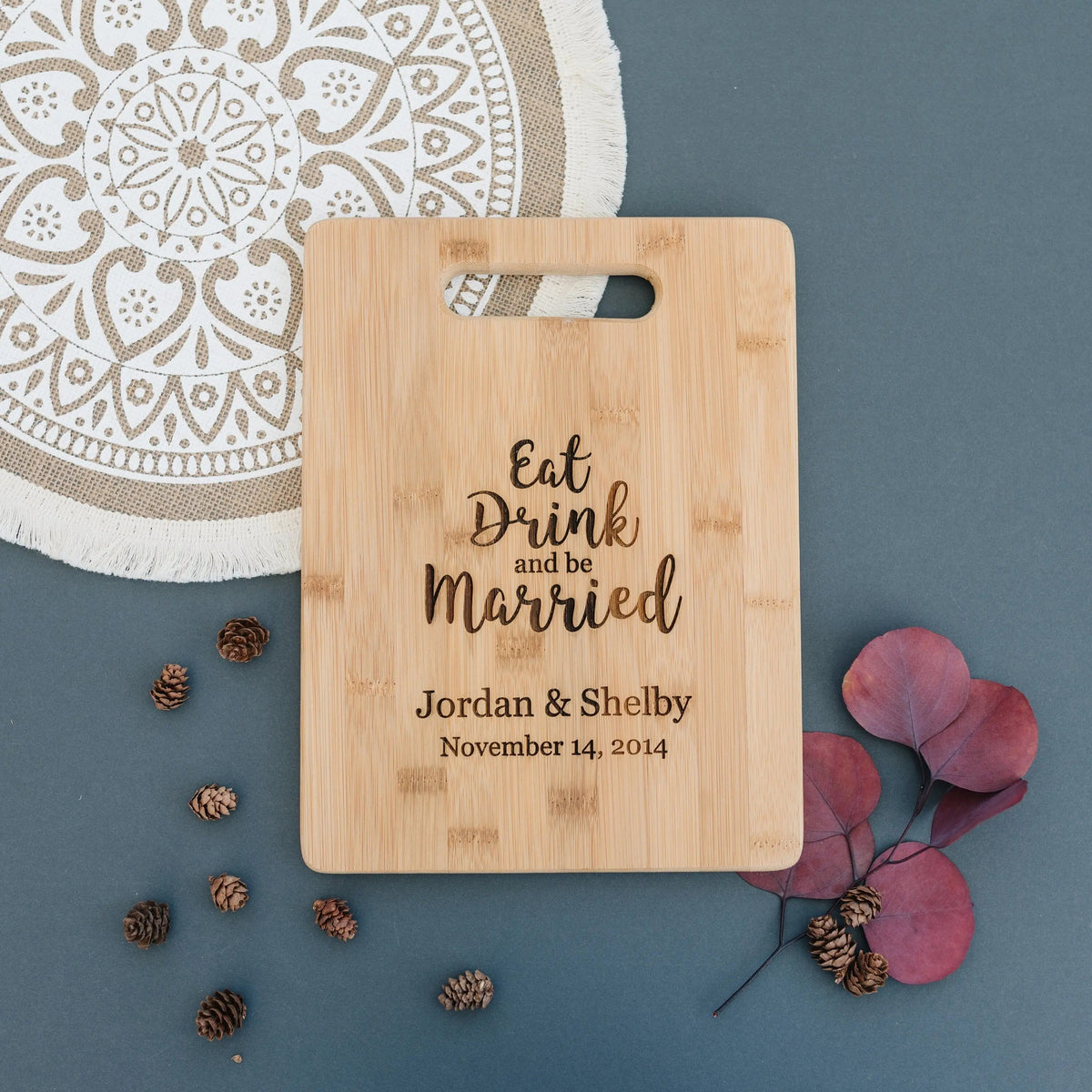 Bamboo cutting board with handle, engraved "Eat Drink and be Married" and couple names.