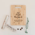 Light bamboo cutting board with handle, engraved wedding message and couple date.
