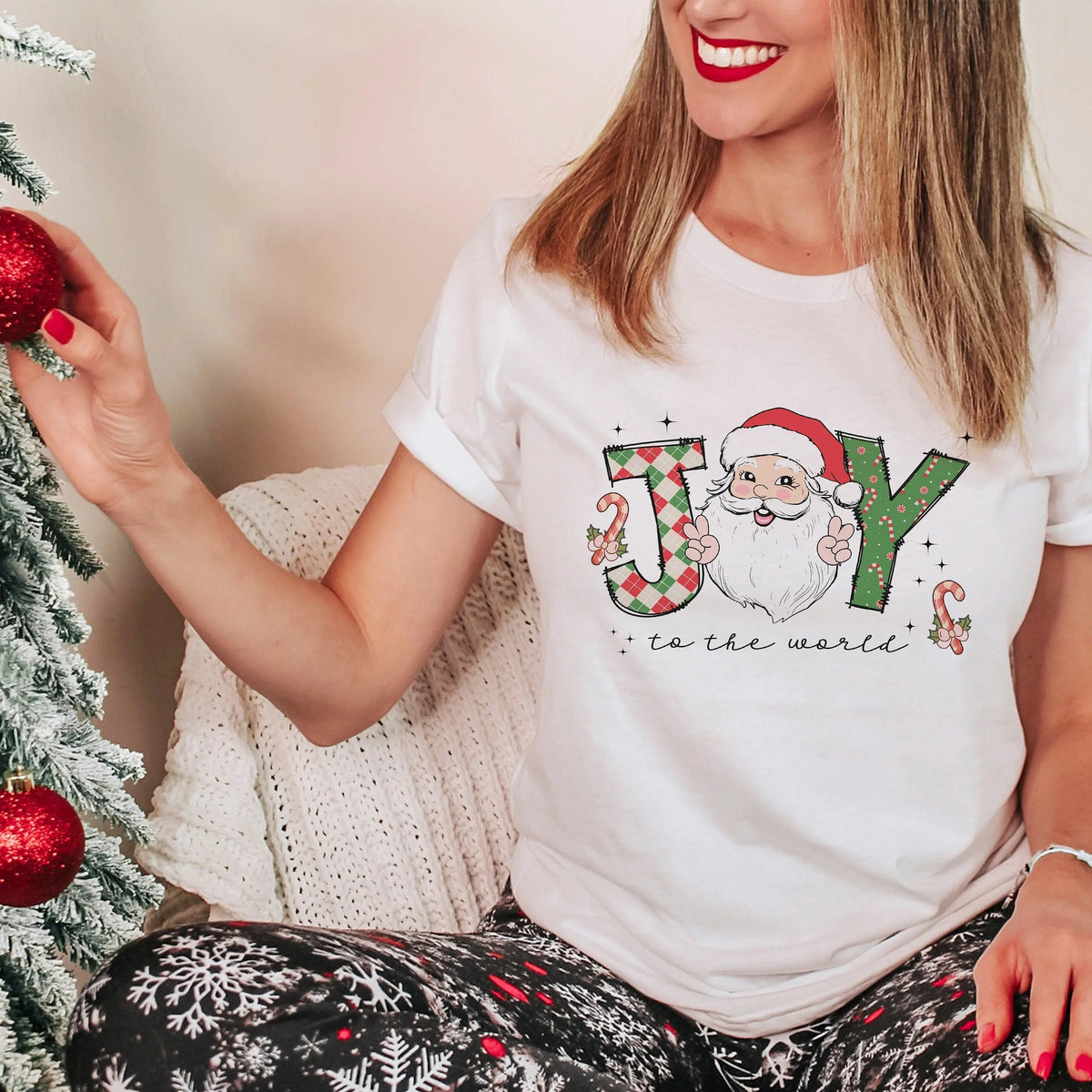 White crewneck Christmas t-shirt with Santa graphic and 'to the world' text