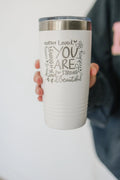 White inspirational tumbler with stainless lid and motivational message text on front.