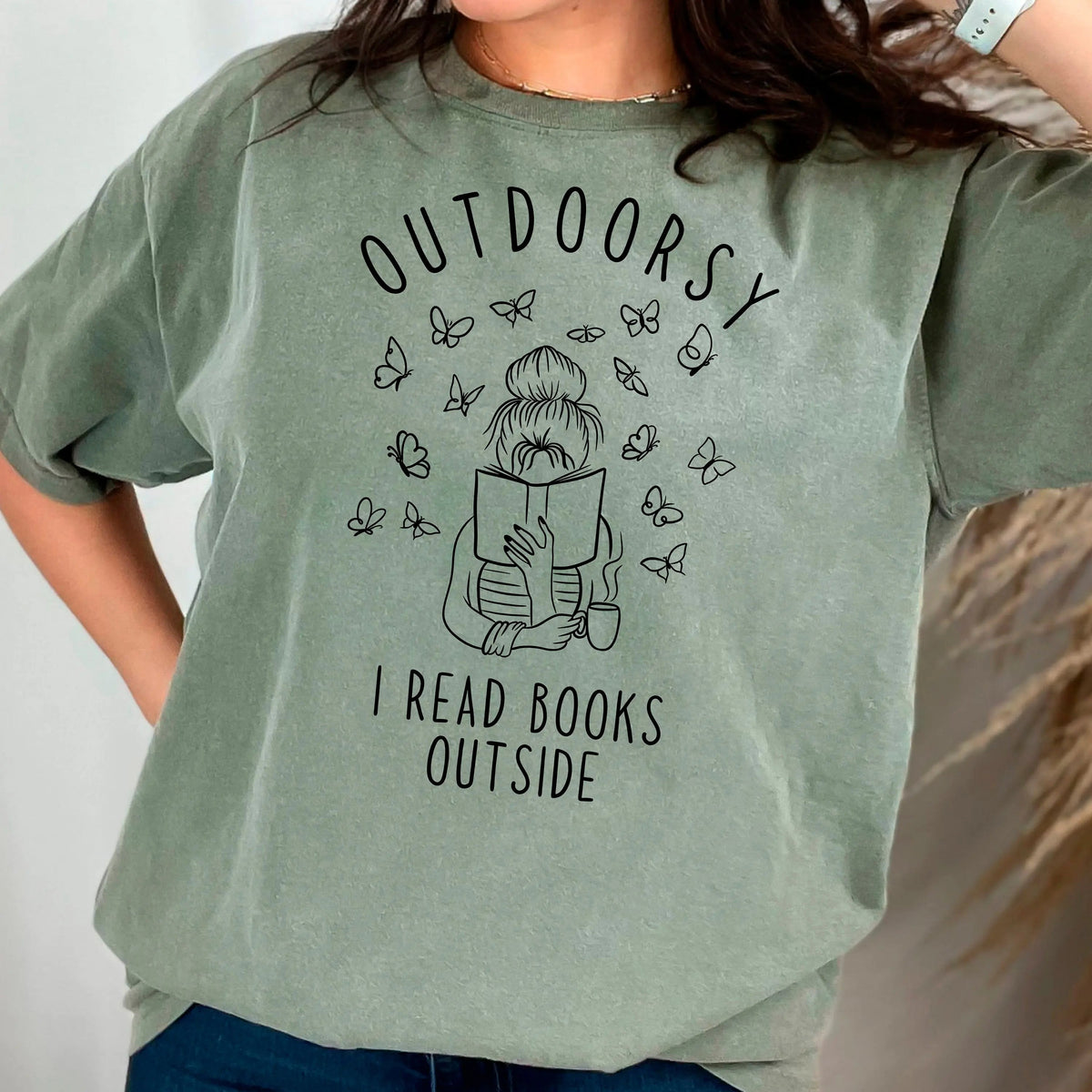 Forest green t-shirt with outdoorsy book graphic, butterflies, and 'OUTDOORSY' text.