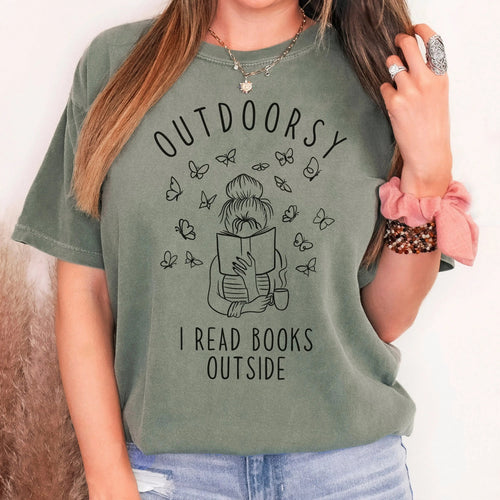 Dark green t-shirt with book-and-butterflies graphic and text 'I READ BOOKS OUTSIDE'.