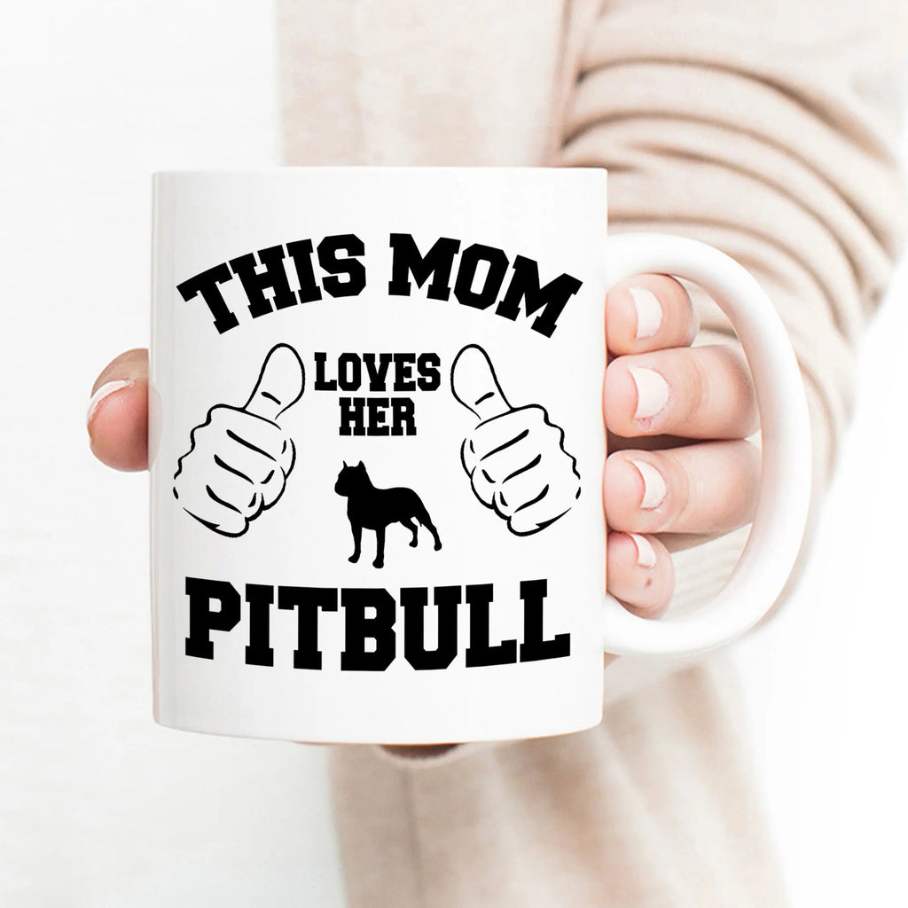White ceramic mug with 'This Mom Loves Her Pitbull' text and black dog graphic