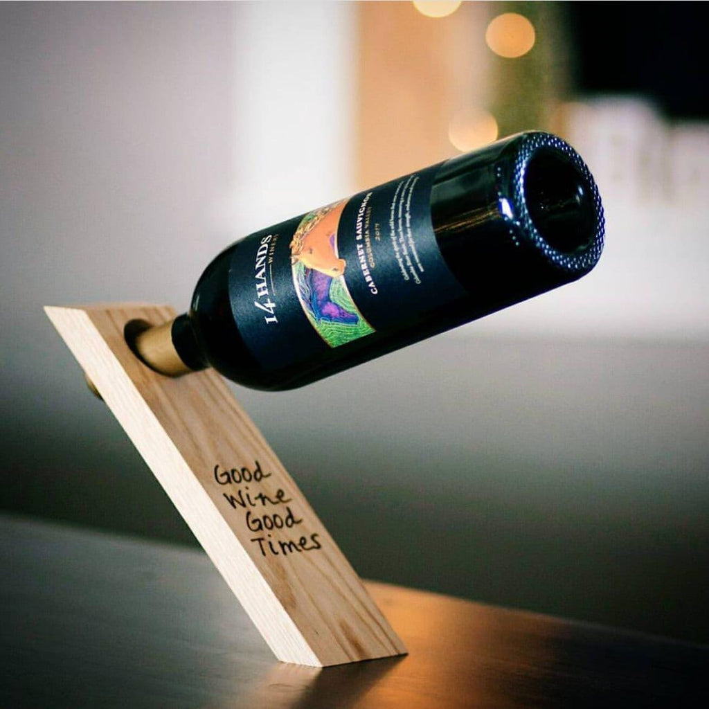 Light wood gravity wine bottle balancer with cork stand and “Good Wine Good Times” text