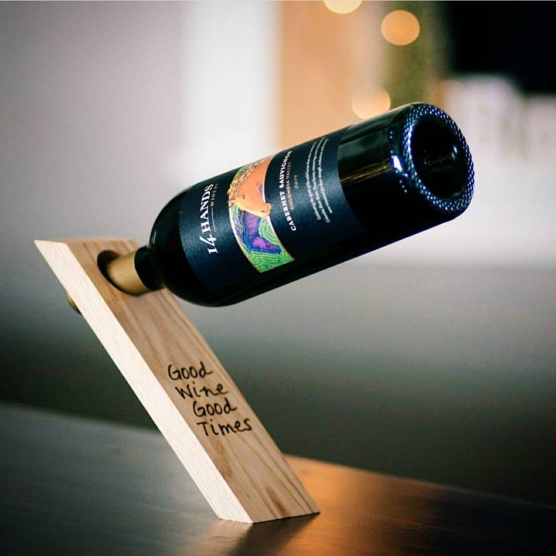 Light wood gravity wine bottle balancer with cork stand and “Good Wine Good Times” text