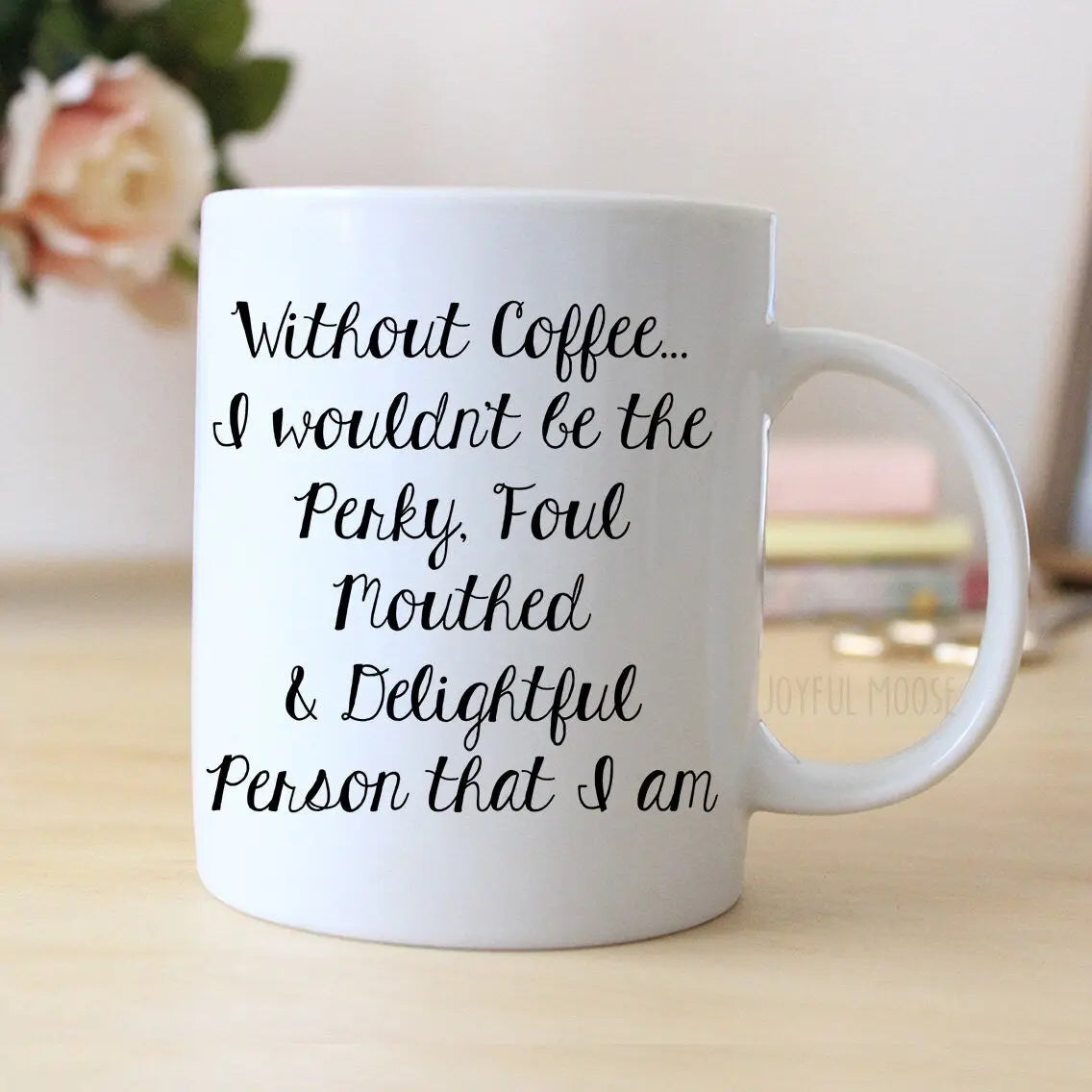 White ceramic coffee mug with black cursive quote on the front